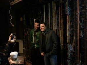 Markus Schulz and KhoMha in front of an old wiring panel.
